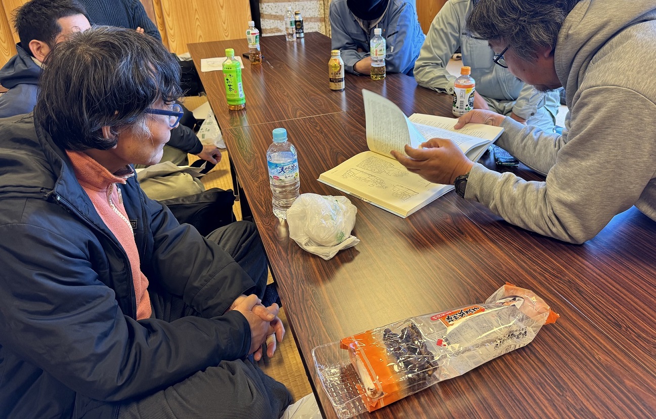 直島町屏風島の公民館で討論中の市村先生（手前左）